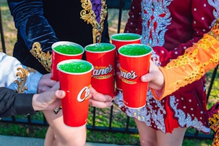 five hands holding up raising canes leprechaun lemonades