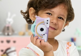 childing holding a rainbow camera 