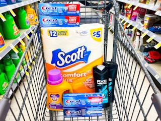 hand holding crest toothpaste and oral-b toothbrush