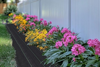 flower beds next to landscaping fabric