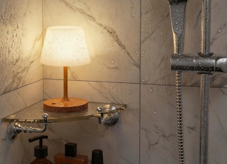 a cordless lamp on a shelf in a shower