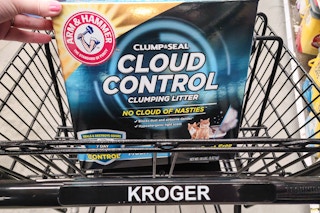 hand propping up a box of arm & hammer cat litter in kroger shopping cart