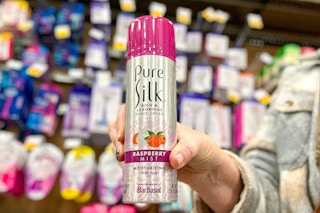 hand holding a can of pure silk shaving cream