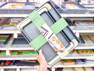 hand holding a figmint baking sheet set in front of a target shelf