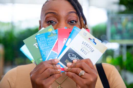 a woman holding gift cards