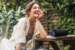 Person enjoying listening to Wireless Bluetooth Speaker