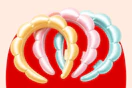 Pastel yellow, pink, and blue bubble headbands arranged on a red background