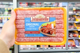 hand holding a pack of johnsonville sausages