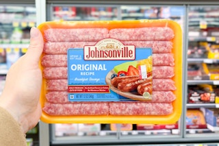 hand holding a pack of johnsonville sausages