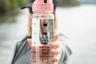 a hand holding a water bottle