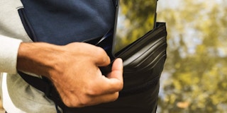 A man pulling his phone out of a fanny pack