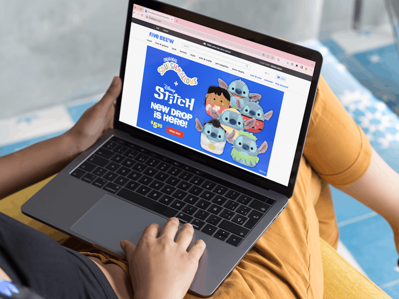 A person using a laptop looking at the Squishmallows on Five Below's website