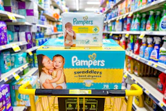 pampers swaddlers diapers and baby wipes stacked in yellow shopping cart