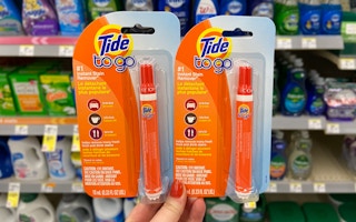 hand holding two Tide to go stain eraser pens