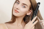 woman using black Nicebay flat iron on hair