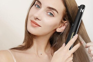woman using black Nicebay flat iron on hair