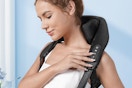 woman wearing a neck and shoulder massager