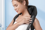 woman wearing a neck and shoulder massager