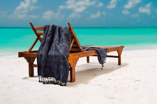 whitley willows sand free beach towel set lifestyle image on a beach lounge chair at the beach