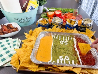 a tray of dips made into a football field