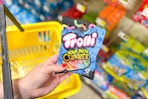 hand holding a bag of trolli sour brite crawlers