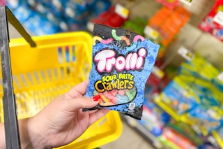 hand holding a bag of trolli sour brite crawlers