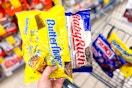 hand holding butterfinger and baby ruth chocolate candy bags