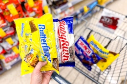 hand holding candy bags with fun size butterfinger and baby ruth