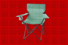 green camp chair on a red background