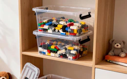 Lego bricks in storage bins on a shelf