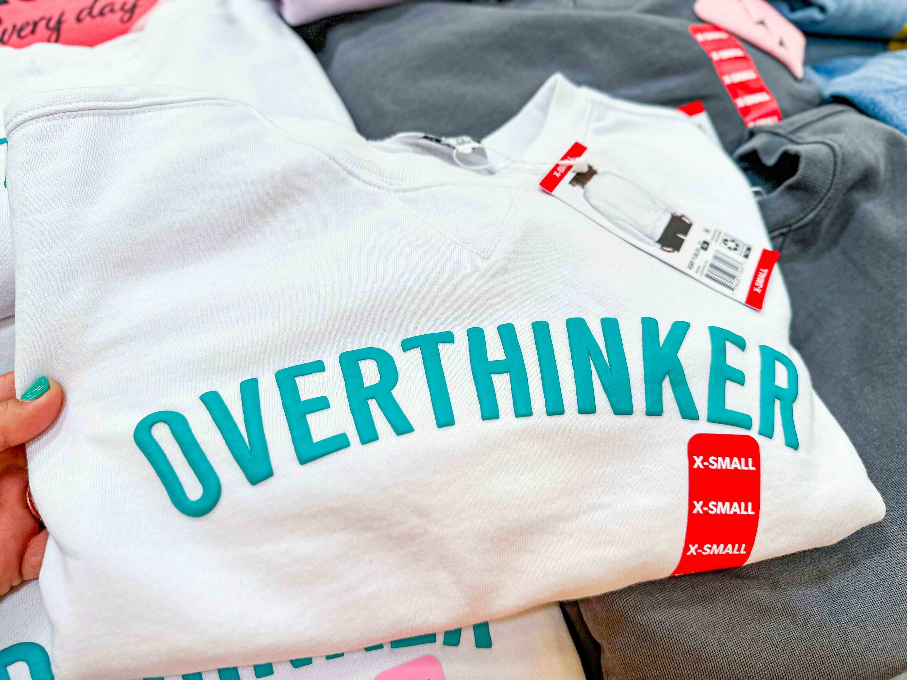 graphic sweatshirt that says "overthinker"