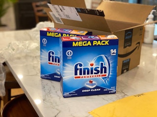 Two Finish dishwasher mega packs in front of an open Amazon box.