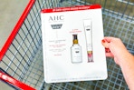 hand putting ahc skincare in shopping cart