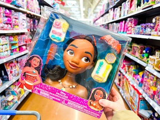 hand holding disney moana styling head in walmart aisle