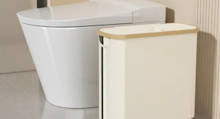 a toilet paper storage basket next to a toilet 