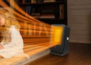 a person sitting in front of a heater
