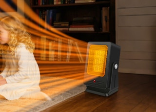 a person sitting in front of a heater