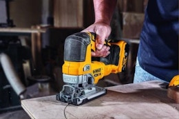  Man using the DEWALT 20V MAX XR Jig Saw on a board.