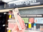 person holding neutrogena mascara in front of a display