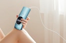 a person using a laser hair removal devicw
