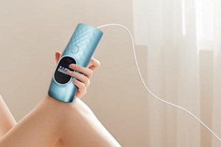 a person using a laser hair removal devicw