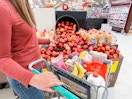 a person shopping for apples at a grocery store