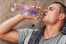 man drinking from propel bottle