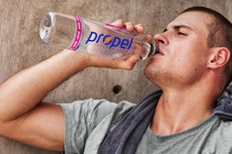 man drinking from propel bottle