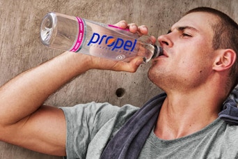 man drinking from propel bottle