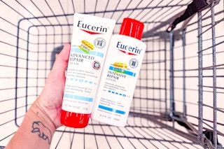 person holding eucerin lotions over a cart