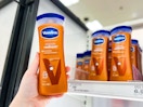 hand holding a bottle of vaseline lotion in front of a target shelf
