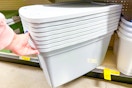 hand grabbing true living storage totes at dollar general