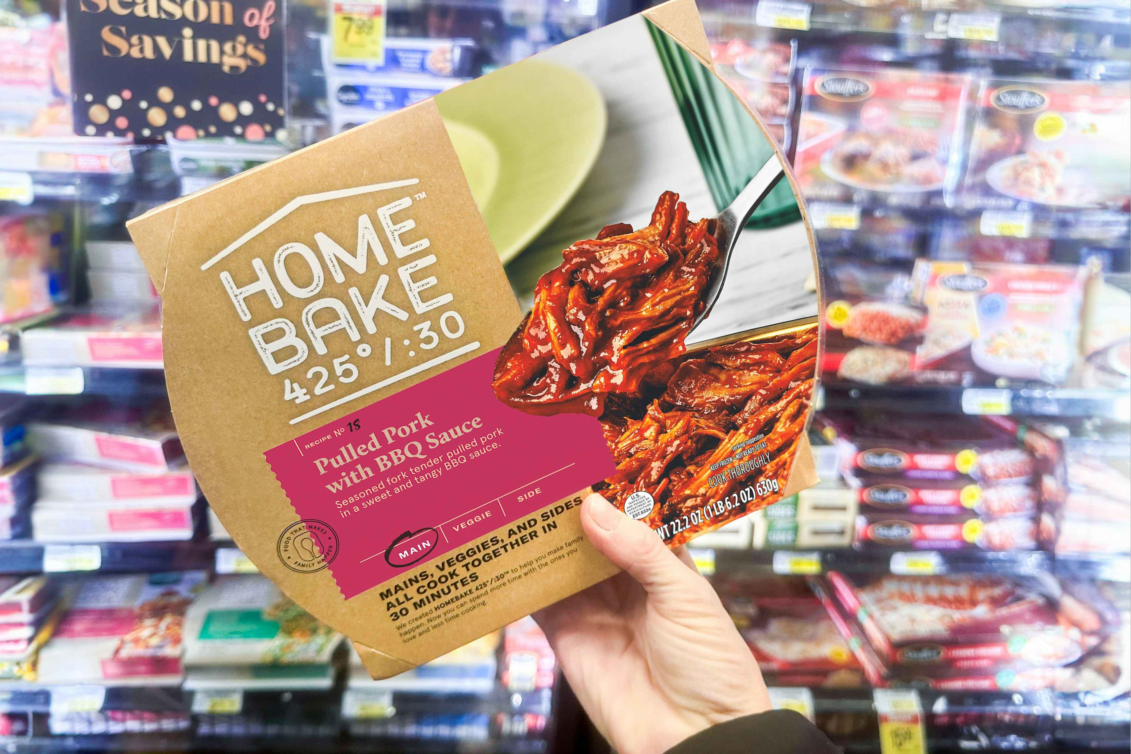 someone holding a home bake meal in a store