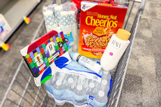 Shopping cart with Cheerios, Neutrogena, Raw Sugar, cups, water, and a FIFA t-shirt